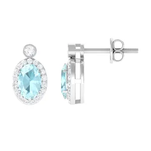 Oval Sky Blue Topaz Halo Stud Earrings with Diamond in Prong Setting